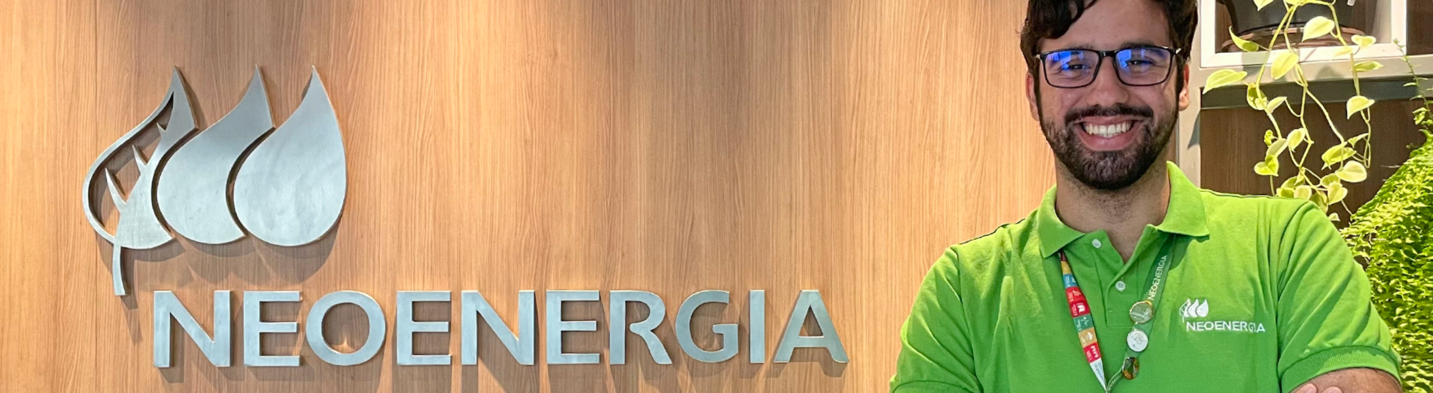 Estagiário da Neoenergia Coelba em frente ao painel da Neoenergia
