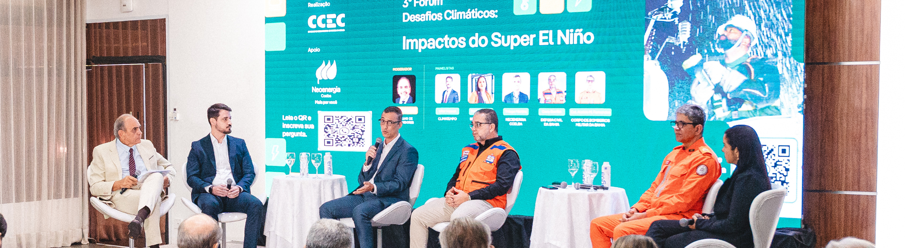 Representantes de instituições falam em palco do evento Desafios Climáticos: Impactos do Super El Niño. Imagem mostra lideranças em palco e plateia assistindo ao evento.